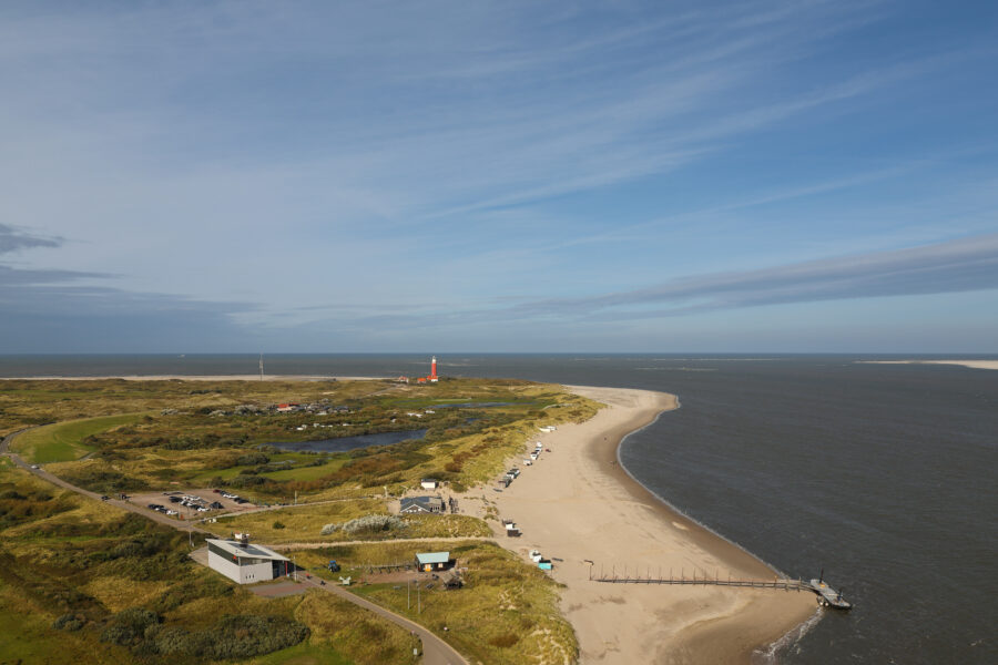The lighthouse on Texel Island stands tall at the jetty, symbolizing a picturesque holiday destination in the Netherlands.