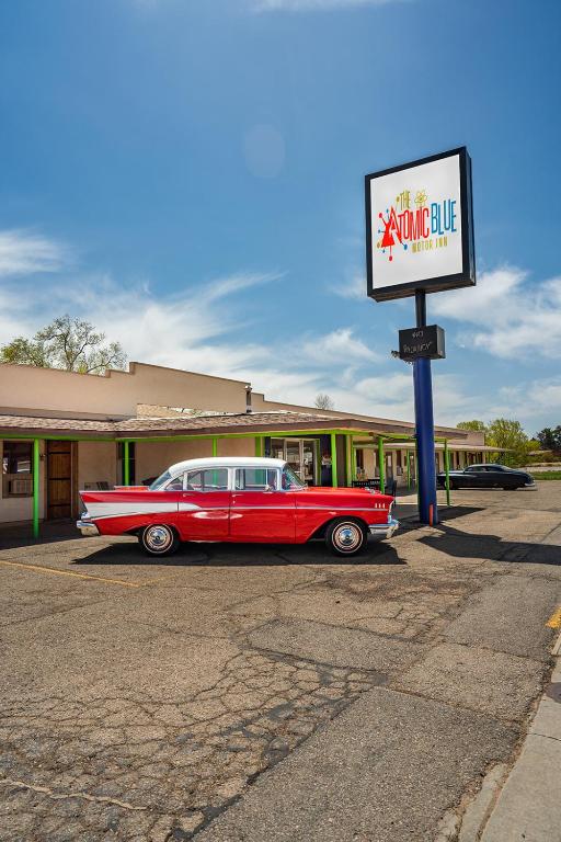 Exterior view of The Atomic Blue Motor-Inn in Utah, showcasing its vibrant blue color and retro design.
