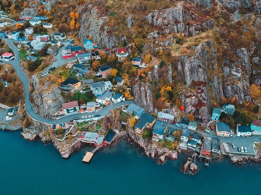 Aerial perspective of The Battery, a quaint coastal village in St. John's, Newfoundland, featuring vibrant homes and ocean views.