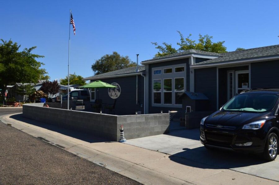 The Bear's Den B&B features a black Ford van parked in front, highlighting the inviting entrance of the house.

