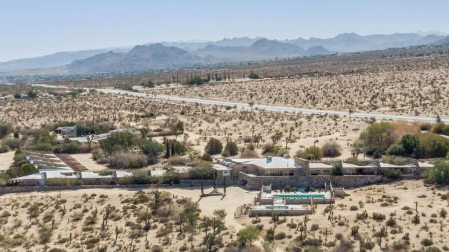 Aerial view of The Bungalows by Homestead Modern, a desert home surrounded by vast, arid landscape.