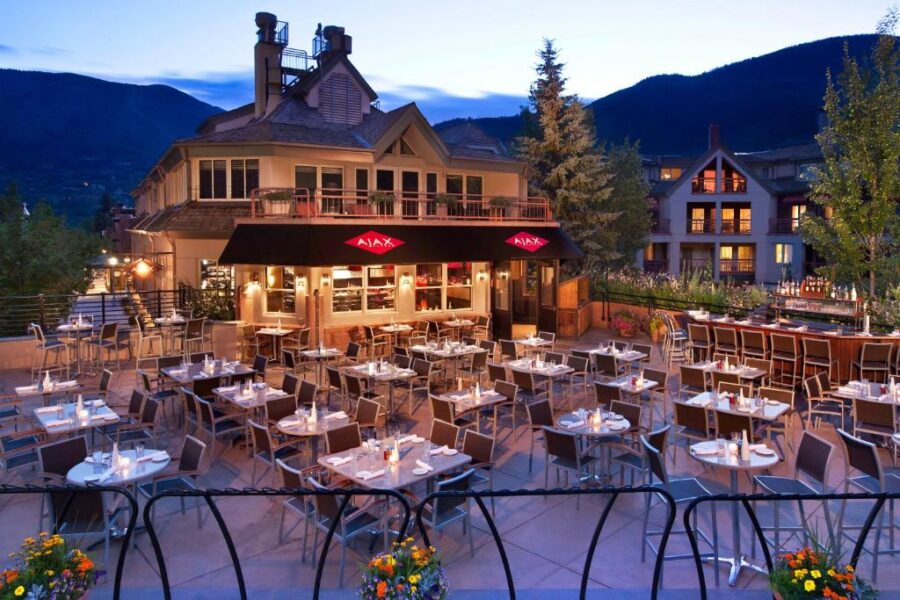 Dining area of The Little Nell restaurant in Aspen, showcasing stylish decor and a warm, inviting atmosphere.