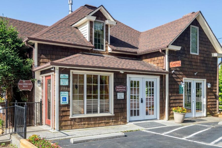 Front view of The Ridgeway Inn, a small brown house with a parking lot in North Carolina.