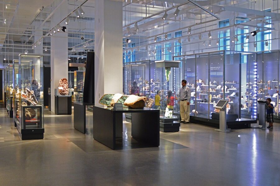 Visitors exploring different exhibits at the Royal Ontario Museum, engaging with various artifacts.
