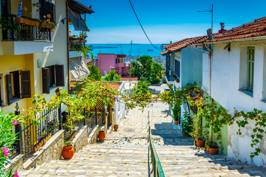 Narrow street in the old town of Thessaloniki, Greece, lined with historic buildings and cobblestone pavement