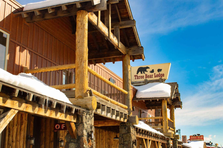 Exterior view of a building with a sign that says "Three Bear Lodge," indicating its name and purpose.