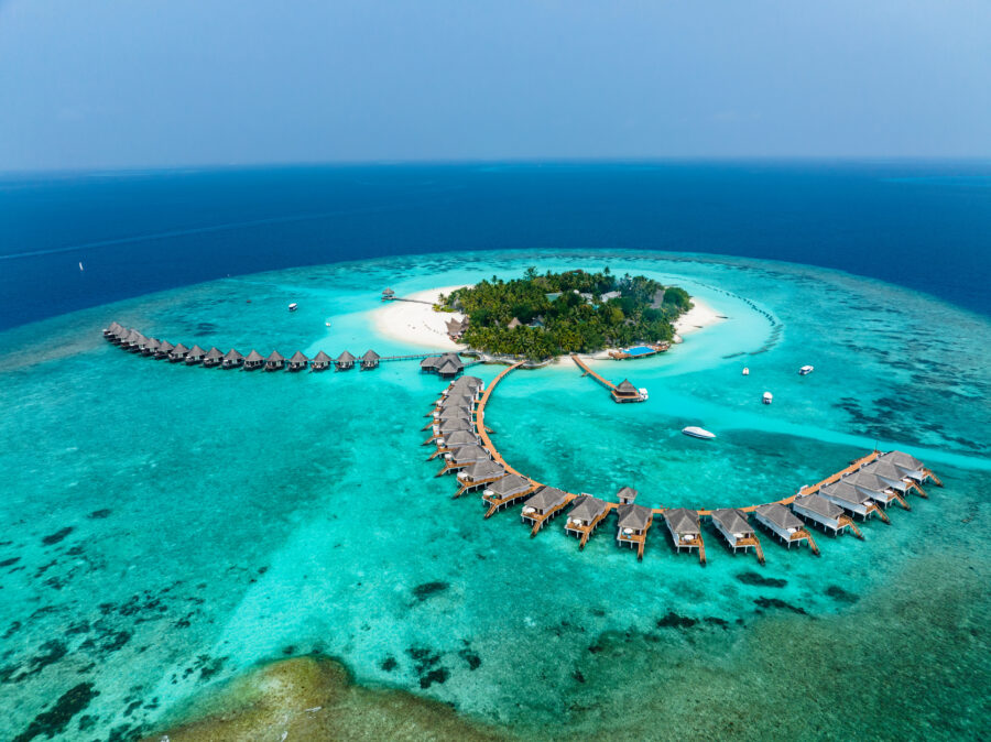 Stunning aerial shot of Thulhagiri Island Resort, featuring water bungalows in the turquoise waters of North Malé Atoll