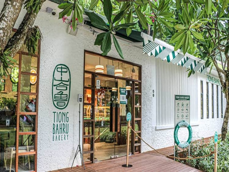 Tiong Bahru Bakerys inviting exterior with modern design and lush greenery.