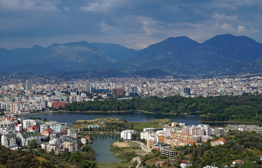 The expansive Tirana Panorama Artificial Lake, with the Great Park in the foreground, reflecting a serene water scene.