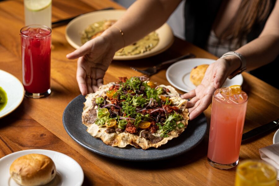 Tlayuda topped with Oaxaca cheese, showcasing traditional Mexican cuisine from Oaxaca, Mexico