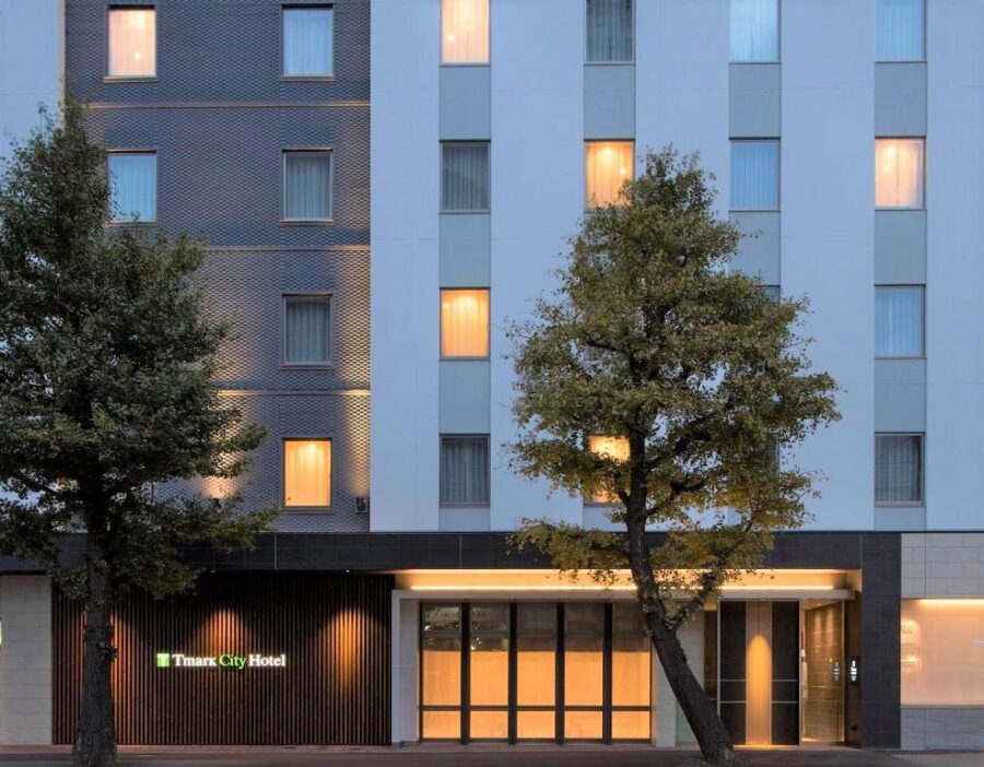 Modern Tmark City Hotel Sapporo Odori exterior at dusk with lit windows and entrance.