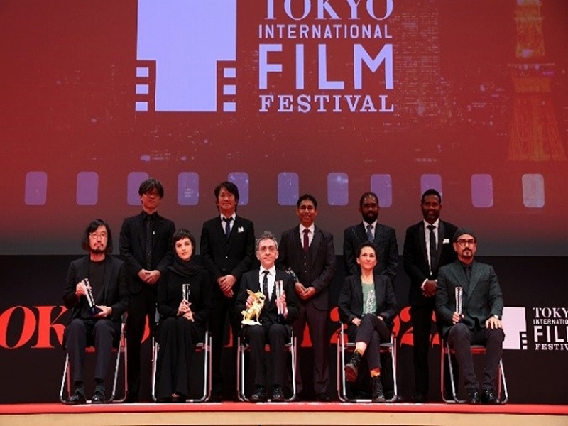 Award winners on stage at Tokyo International Film Festival with festival logo in the background.
