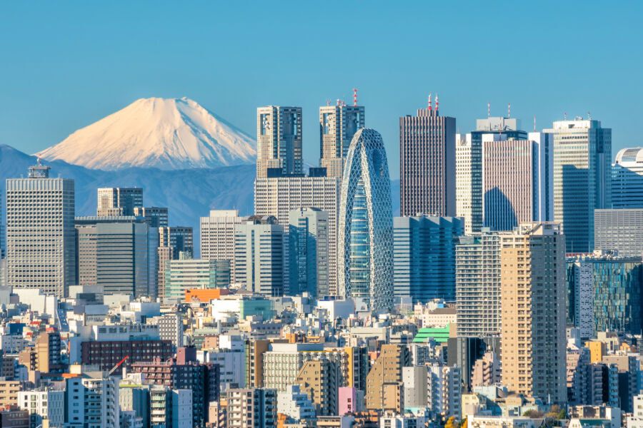Tokyo skyline with skyscrapers in the foreground and Mount Fuji majestically rising in the background