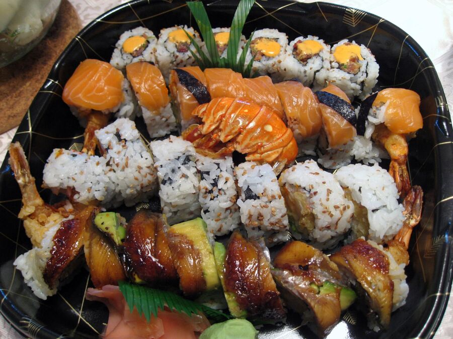 Sushi rolls with shrimp, crab, and vegetables on a plate, presented in Toronto, Canada.
