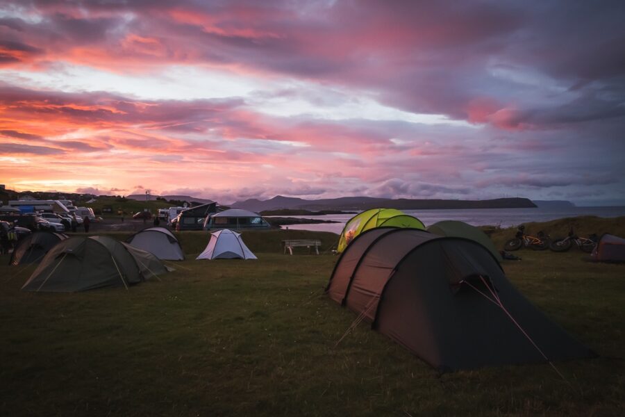 Sunset view of tents set up on grass at Tórshavn Camping, Tórshavn, Faroe Islands.