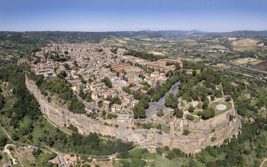 Aerial view of Civita di Bagnoregio, showcasing medieval architecture and scenic Italian countryside.