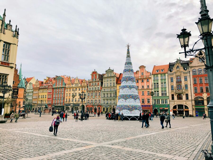 Christmas tree at Wroclaw market square, Poland, with historic colorful townhouses.
