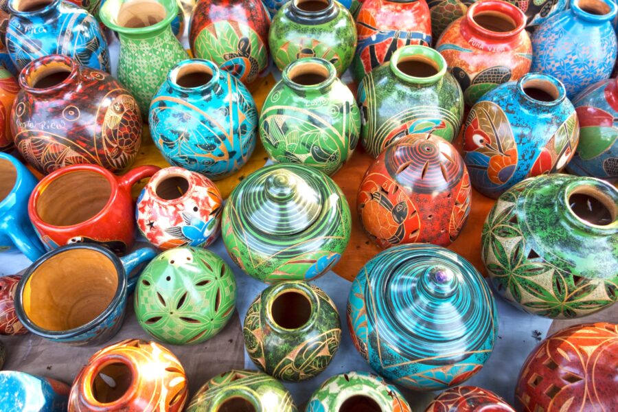 Colorful Costa Rican porcelain pottery and crafts displayed as souvenirs at an outdoor market near Manuel Antonio National Park