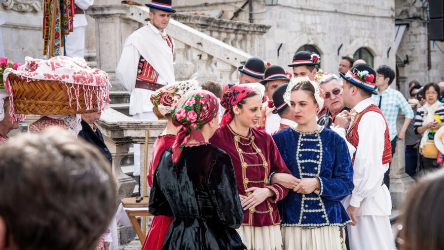 Croatian festival: women in vibrant traditional attire, community celebration, rich cultural heritage.