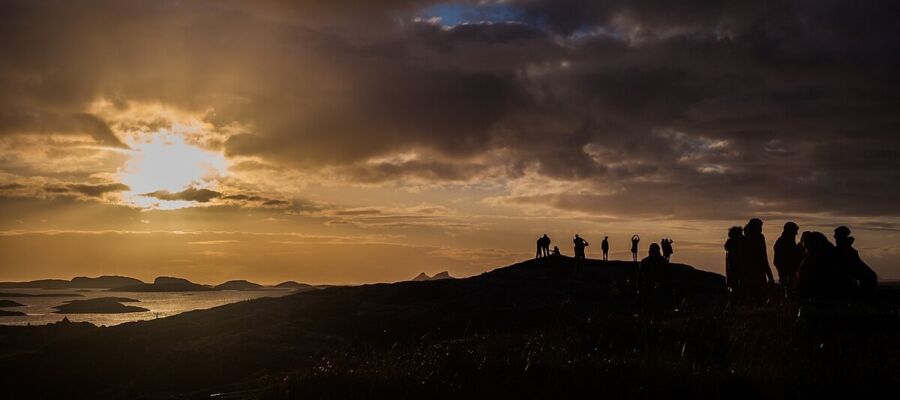 Sunset silhouettes at Trænafestivalen showcase stunning Norwegian coastlines and festival spirit.