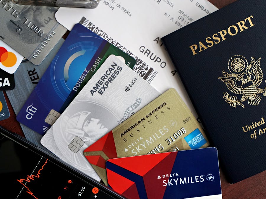 Travel essentials: credit cards, US passport, receipts, smartphone, highlighting finance and exploration.