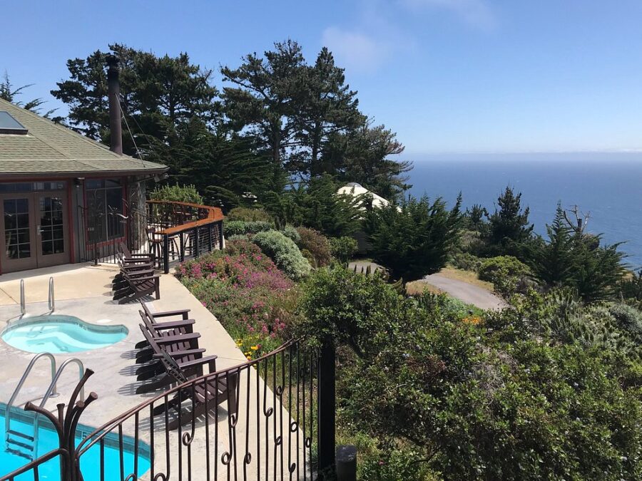 Panoramic ocean view from the deck of a house at Treebones Resort in Big Sur, featuring vibrant blue waves and coastal scenery.