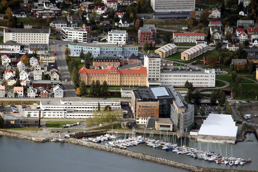 Tromsø City Centre showcasing a bustling skyline with various buildings and boats in the water.