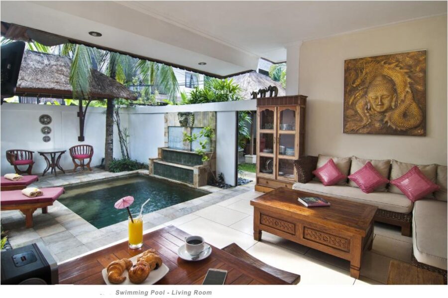 Luxury Bali villa living room with private pool, tropical garden, outdoor lounge, and breakfast.