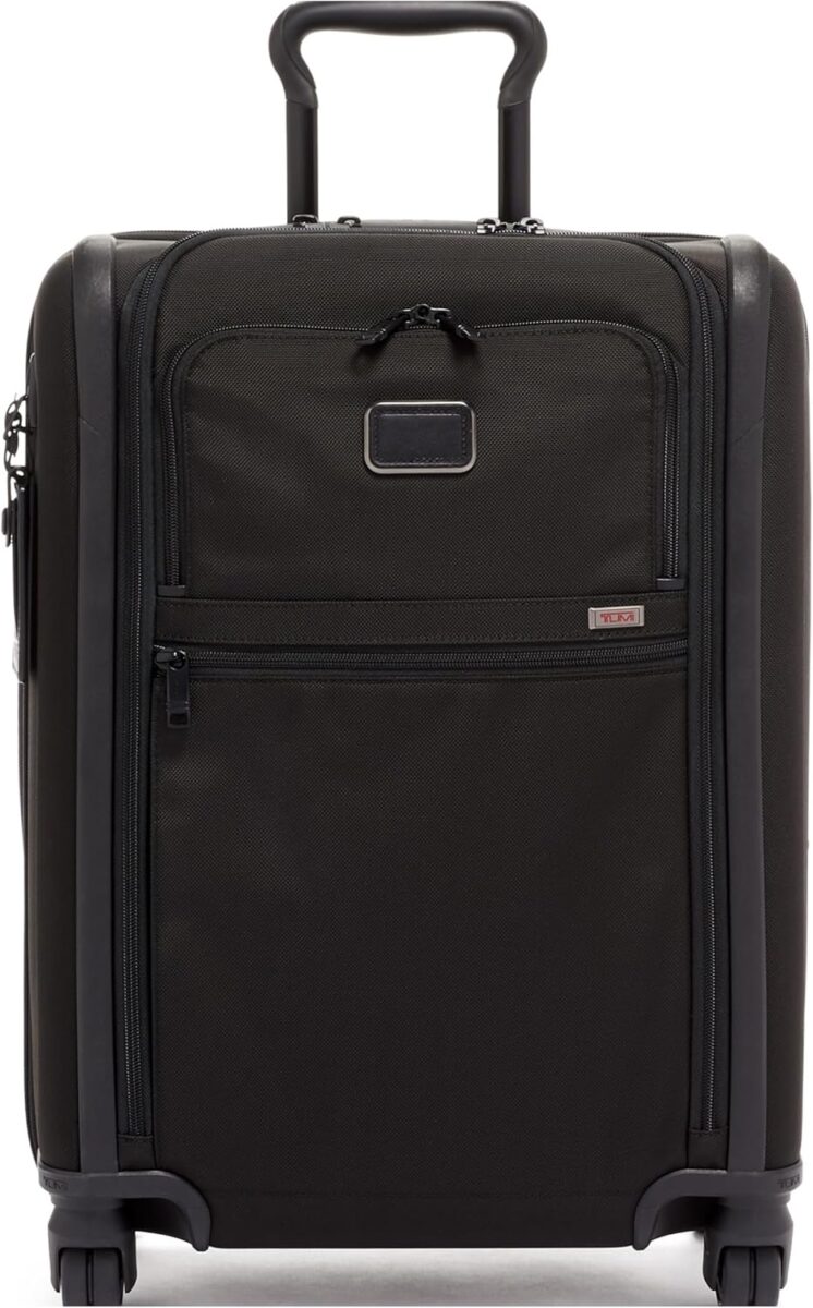 Two suitcases labeled "TUMI" and "Briggs & Riley," showcasing the TUMI Alpha Continental Expandable Carry-On luggage.