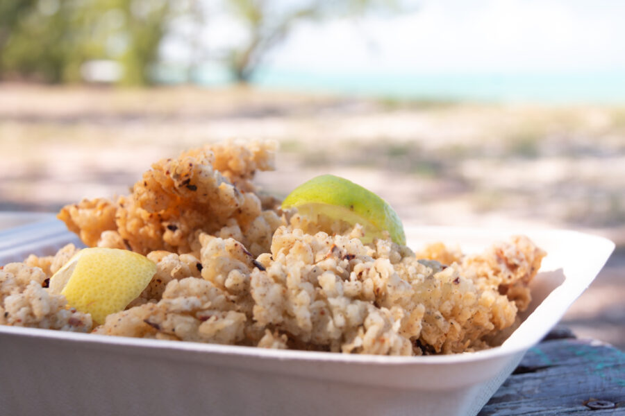 Close-up of a food container filled with broken conch, a popular seafood dish in the Turks and Caicos Islands.