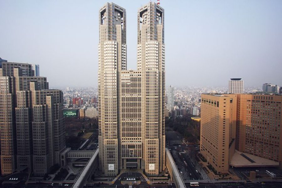 Tokyo Metropolitan Government Building twin-tower skyscrapers in urban cityscape skyline.