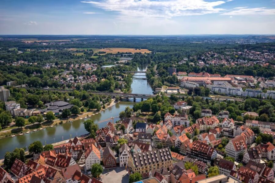 Aerial view of Ulm, Germany, showcasing the cityscape and surrounding landscape in a panoramic perspective.
