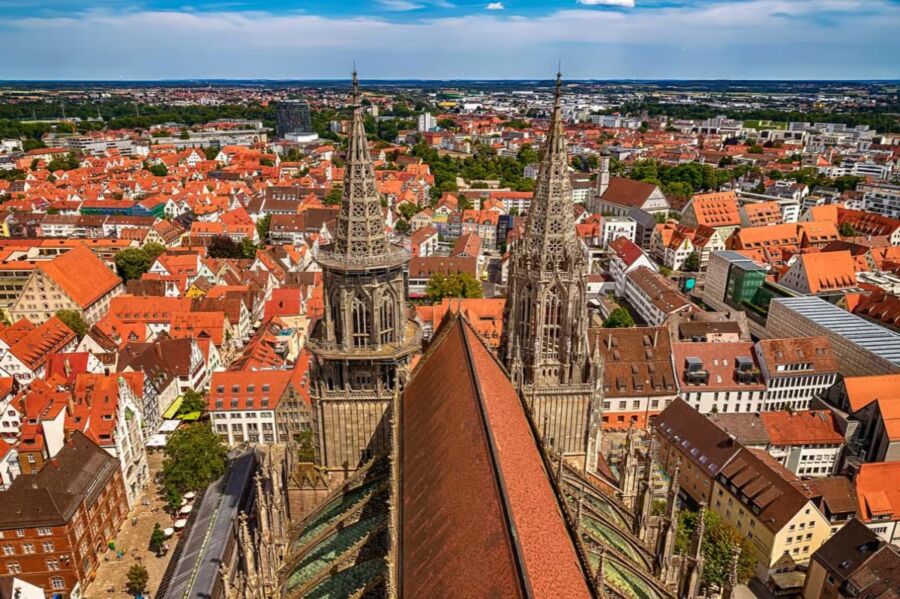 The skyline of Munich, Germany, featuring notable buildings and a bustling urban atmosphere.
