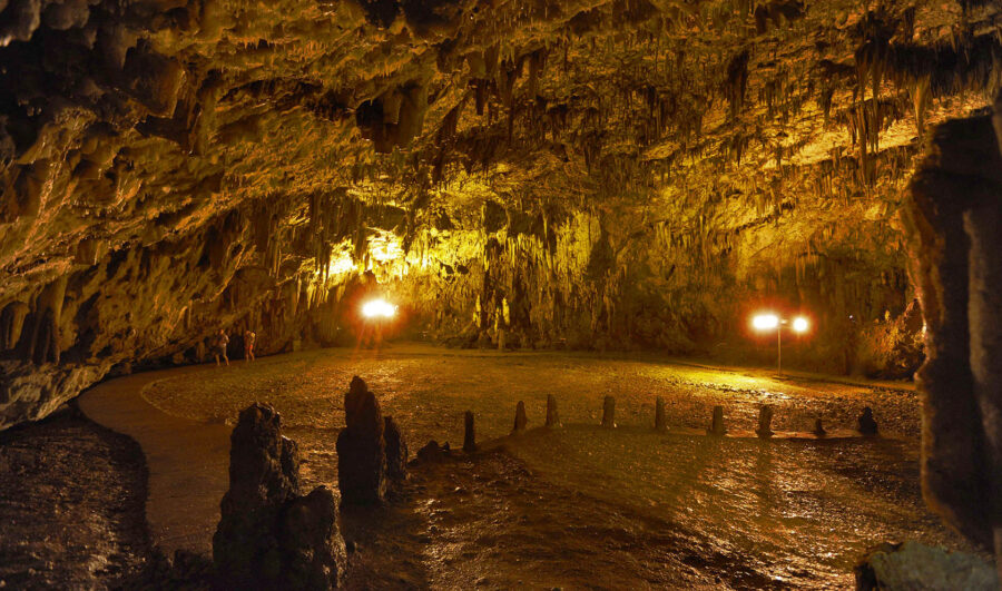 Tour through majestic Drogarati Cave with stalactites, rock formations, and warm lighting.