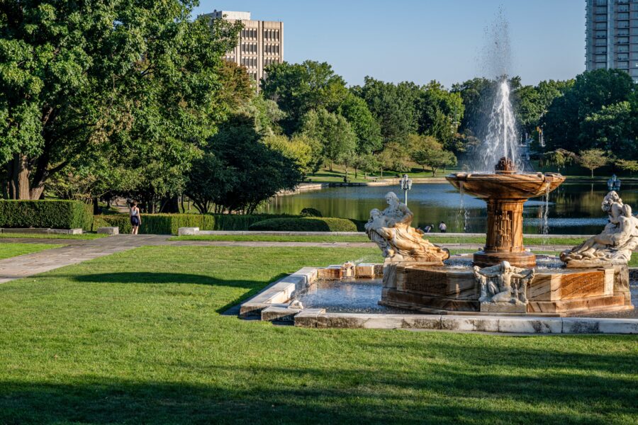 Fountain in University Circle, Cleveland, Ohio, surrounded by greenery and buildings, creating a serene urban atmosphere