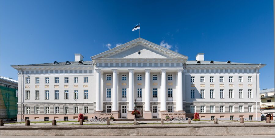 Tartu University neoclassical facade with six columns, steps, and flag at Ülikooli 18.