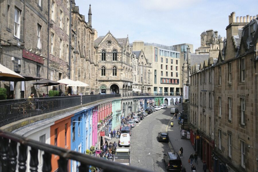 Vibrant city scene showcasing historical and modern architecture, lively streets, and colorful buildings.