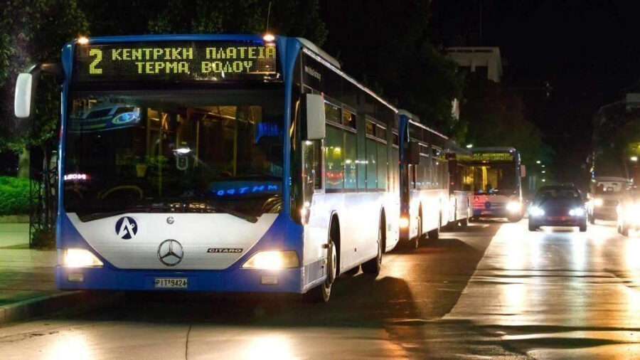 Nighttime urban scene featuring modern public buses in Volos, Greece transportation hub.