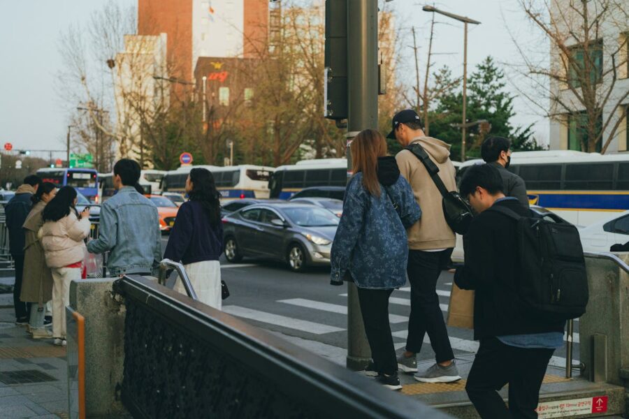 Bustling city street scene with pedestrians, vehicles, and vibrant urban life at dusk.
