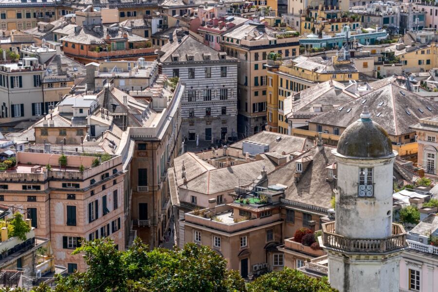 Panoramic view of European city with historic architecture, colorful rooftops, and iconic tower.