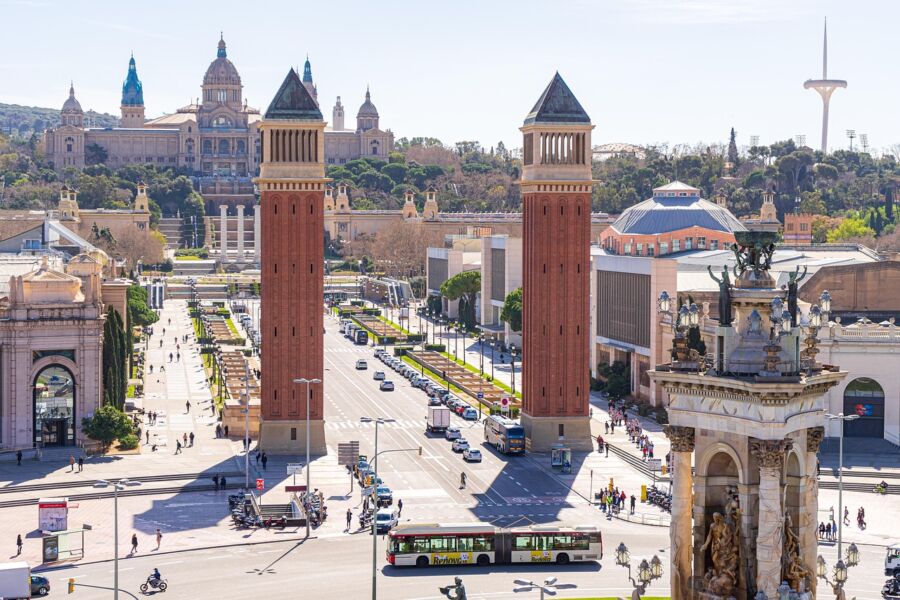 Barcelona urban landscape with historic towers, pedestrian walkways, and modern architecture.