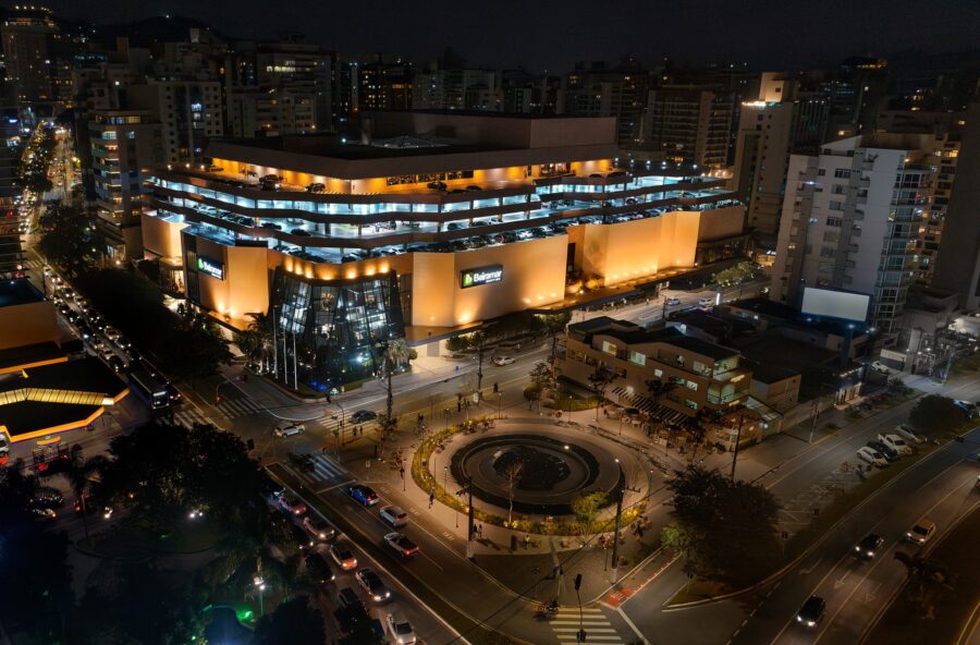 Night aerial view of illuminated Beira-Mar Shopping mall, city roundabout, fountain and surrounding skyscrapers.