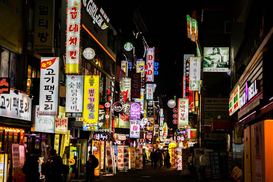 Vibrant South Korean street with neon signs and bustling nightlife.