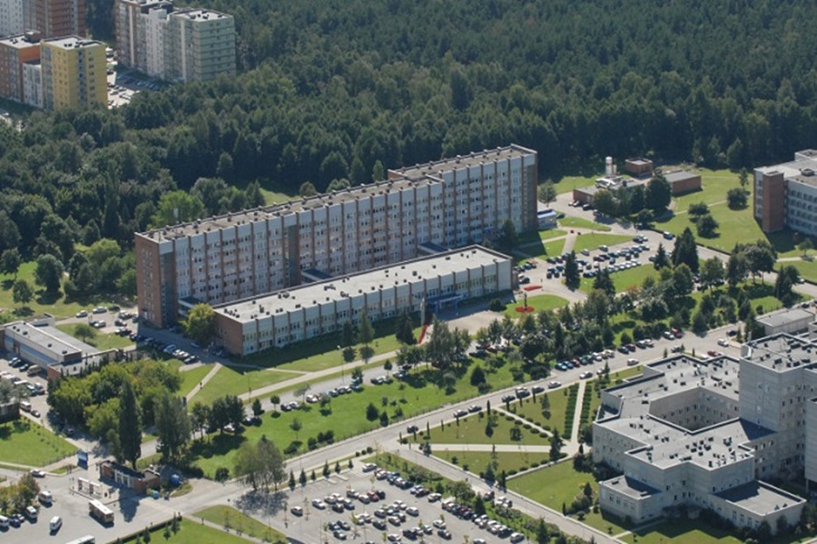 Aerial view of suburban residential area with mixed-use buildings and green spaces.
