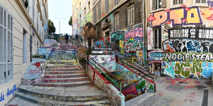 Vibrant urban street art decorates steps and walls at Notre Dame du Mont, blending graffiti and culture.