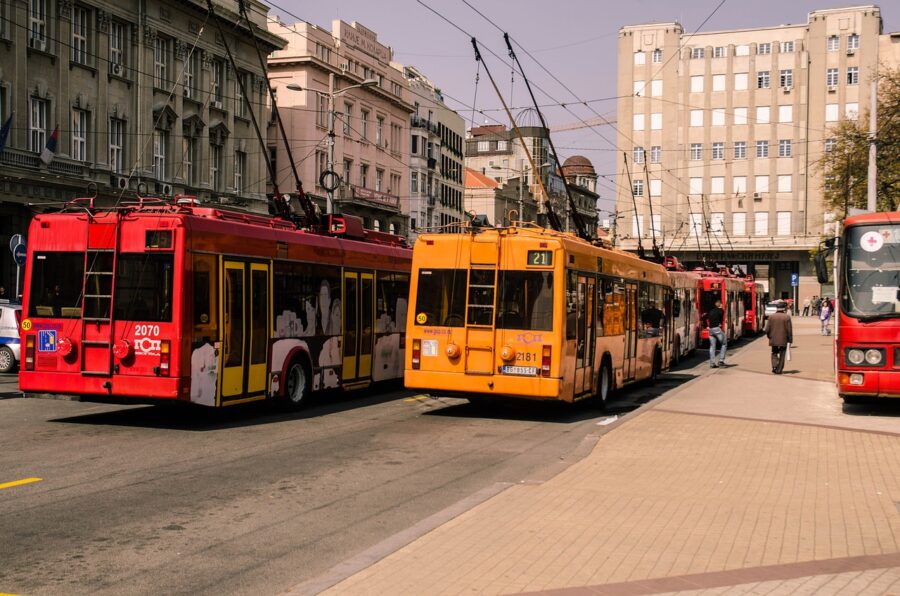 Bustling urban trolleybus scene in Belgrade featuring diverse colors and vibrant street life.