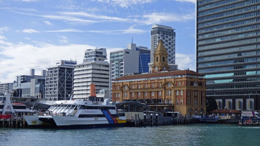 Bustling harbor: modern skyscrapers, historical architecture, colorful ferry, vibrant waterfront scene.