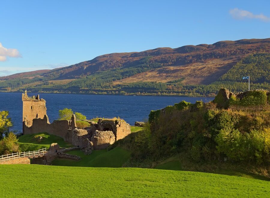 Urquhart Castle stands majestically on a hill, overlooking the tranquil waters of Loch Ness.