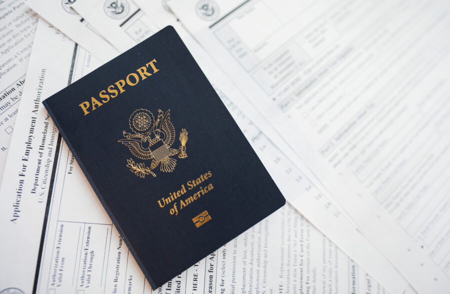 Close-up of a US passport alongside essential travel documents, including tickets and itineraries.
