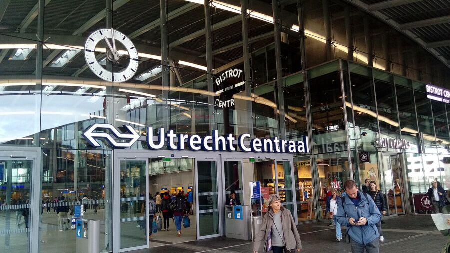 Crowds of pedestrians in front of Utrecht Centraal train station, showcasing the bustling atmosphere.